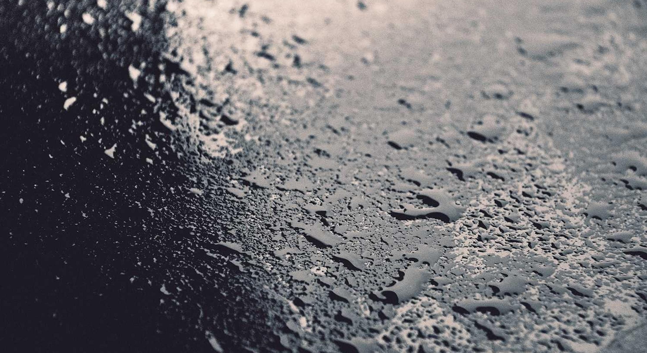 Water beading across dark stone
